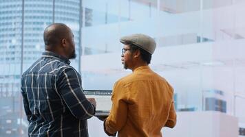 Real estate team and businesswoman discussing workspace design and planning, reviewing layout blueprints during an office tour. Investing in property leasing for startup development. Camera B. photo