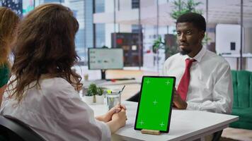 Interviewer and candidate meeting for an interview next to green screen, HR manager asking questions about qualifications and business administration expertise. Recruitment process. Camera B. photo