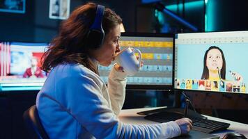 Photographer using editing software to edit photos and make adjustments while enjoying cup of coffee. Specialist color correcting pictures while listening music in headphones, camera B