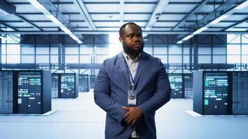 IT expert managing data center with advanced technology, ensuring cybersecurity and efficient network management. Admin in server room maintaining and optimizing data center infrastructure, camera B photo
