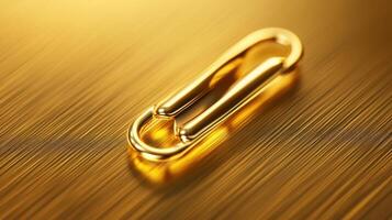 Elegant golden paperclip resting on a polished surface with soft lighting showcasing its shine and texture photo