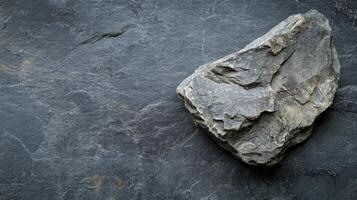 Natural rock formation on slate surface showcasing texture and color variations in a natural setting photo