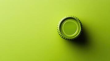 Bottle cap resting on a vibrant green surface capturing the essence of minimalism and simplicity in design photo