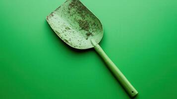 Shovel resting on a vibrant green surface highlights gardening tools and outdoor activities photo