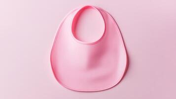 Pink baby bib placed on a soft pastel background for infant feeding settings and child care essentials photo