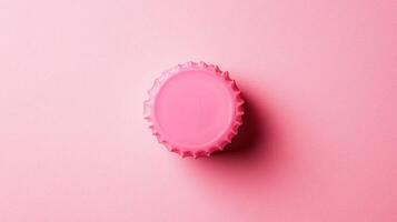 Bright pink bottle cap set against a soft pink background creates a playful and vibrant visual experience photo