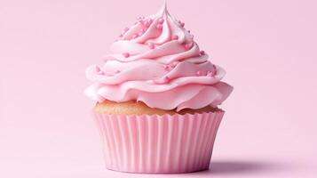 A cupcake with pink frosting on a pink background photo