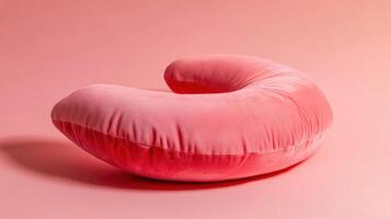 A pink pillow on a pink background photo
