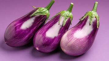 Fresh purple eggplants arranged on a solid background showcasing their vibrant color and appealing texture photo