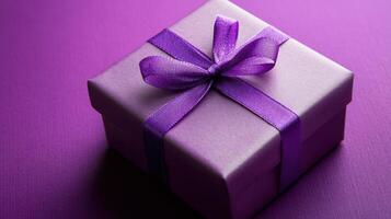 A purple gift box with a purple ribbon on top photo