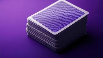 A stack of playing cards on a purple background photo