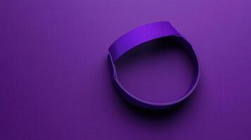 A purple ribbon is sitting on a purple surface photo