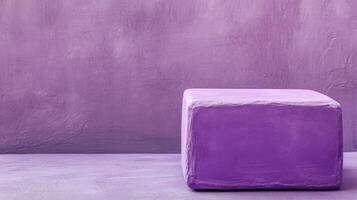 A purple cube sitting on a concrete floor photo