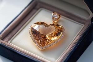 Heart shaped citrine pendant setting in gold surrounded by diamonds in a box photo