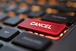 Red cancel key glowing on a modern keyboard photo