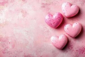 Pink hearts resting on a pink textured surface, creating a romantic scene photo