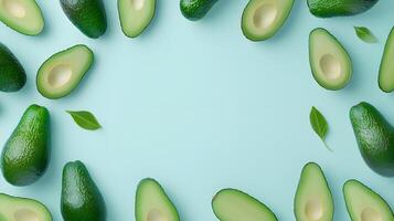Fresh Avocados and Leaves on a Light Blue Background Flat Lay photo