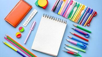 Colorful Stationery and Notebooks on Blue Background for School Use photo
