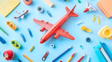Colorful Flat Lay of Stationery and Toy Airplanes on Blue Surface photo