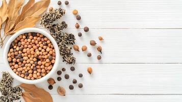 Colorful Spices and Dried Leaves on White Wooden Tabletop photo