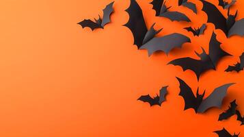 Black Paper Bats on Orange Background for Halloween Decoration photo