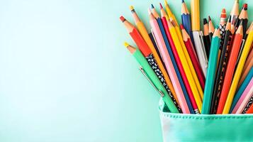 Colorful Variety of Pencils in Container on Light Mint Background photo