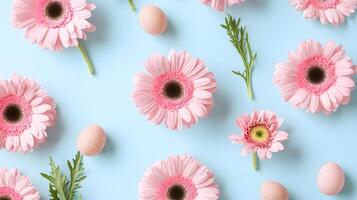 Soft Pink Gerbera Daisies and Eggs on Light Blue Background photo