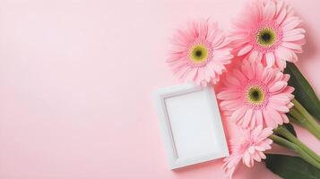Beautiful Pink Gerbera Daisies with Empty Frame on Soft Pink Background photo