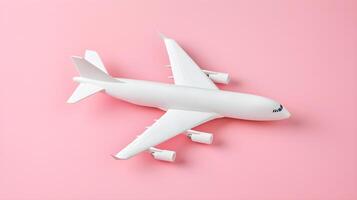 White Airplane Model on Pink Background for Travel Concepts photo