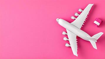 White Airplane Model on Bright Pink Background with Travel Box photo
