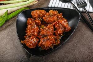 Manchurian chicken with sauce and spices photo