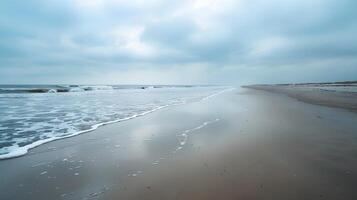 Calm Beach Scene with Overcast Sky and Gentle Waves photo
