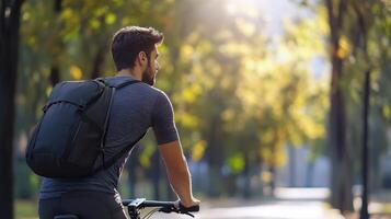 Young Man Riding Bicycle Through Sunlit Autumn Park Pathway photo