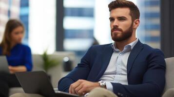 Thoughtful businessman in modern office setting with laptop photo