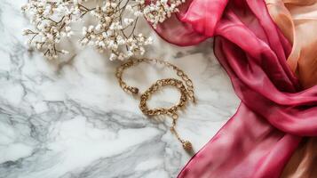Gold Chain and Silk Scarf on Marble. photo