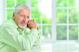 close-up portrait of a senior man thinking about something photo