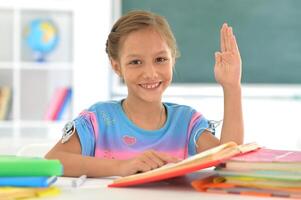Portrait of girl studing with books at classroom photo