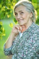 Portrait of a beautiful woman in the park in summer photo