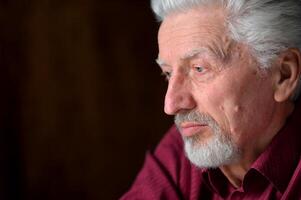 close-up portrait of a senior man thinking about something photo