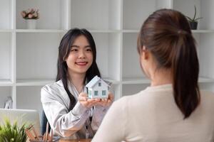 Home sales and real estate agent provide home models to clients to complete sale contract with. photo