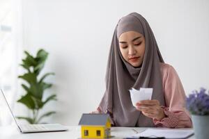 Muslim businesswoman dealing with real estate, buying and selling houses and insurance for real estate photo