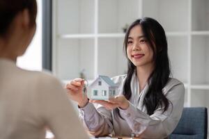 Home sales and real estate agent provide home models to clients to complete sale contract with. photo