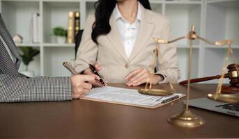 Lawyer and businesswomen discussing and introducing Providing legal advice regarding signing insurance contracts or financial contracts photo