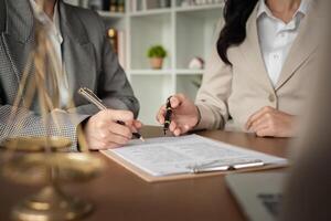 Lawyer and businesswomen discussing and introducing Providing legal advice regarding signing insurance contracts or financial contracts photo
