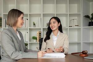 Lawyer and businesswomen discussing and introducing Providing legal advice regarding signing insurance contracts or financial contracts photo