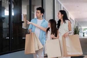 Happy Family Enjoys a Joyful Holiday Shopping Trip Together in a Modern Mall Setting photo