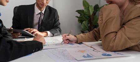 Business Team Collaborating on Data Analysis with Graphs and Charts in a Modern Office Setting photo