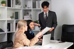 Dynamic Business Team Collaborating on Strategic Work Plans in a Modern Office Setting photo