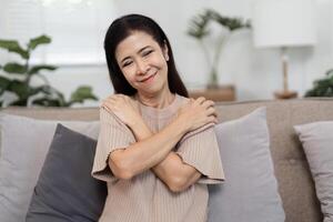 Woman Embracing Herself as a Symbol of Self-Protection and Inner Strength in a Modern Home Setting photo