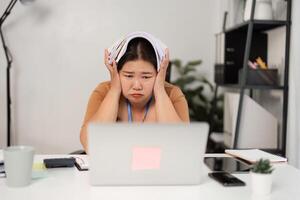 Stressed Businesswoman Overwhelmed with Workload in Modern Office Setting photo